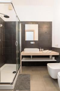 a bathroom with a tub and a sink and a shower at Loft Kala Zèna in La Maddalena