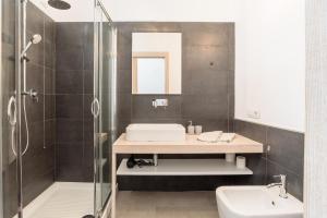 a bathroom with a sink and a shower at Loft Kala Zèna in La Maddalena +19 photos