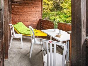 a patio with a table and chairs and a window at Apartment Helene Apt-Diana by Interhome in Wengen