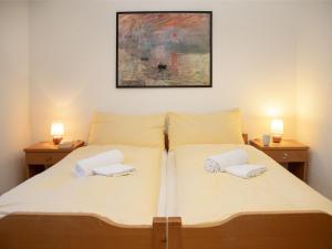 a bedroom with a bed with two pillows on it at Apartment Primula Apt- B by Interhome in Wengen