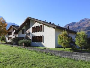 a house with mountains in the background at Apartment Primula Apt- B by Interhome in Wengen