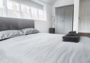 a bedroom with a large white bed with a large window at Cosy & Luxury 2BR Flat in Calverton in Calverton