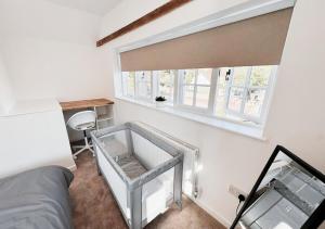 a bedroom with a window and a bed with a glass box at Cosy & Luxury 2BR Flat in Calverton in Calverton +5 photos