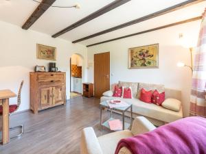 a living room with a couch and a table at Apartment Am Hohen Bogen-64 by Interhome in Kummersdorf