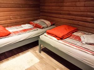 two twin beds in a room with wooden walls at Apartment Am Hohen Bogen-64 by Interhome in Kummersdorf +30 photos