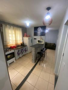 una cucina con un tavolo e sedie in una stanza di Paraíso Montanha e Mar a Peruíbe