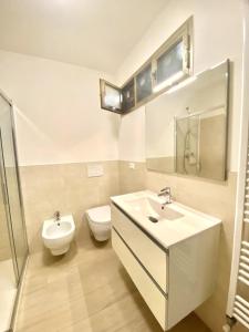 a bathroom with a sink and a toilet at DolceMare - Apartment in Lido di Jesolo