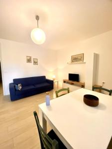 a living room with a blue couch and a table at DolceMare - Apartment in Lido di Jesolo