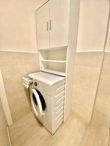 a white washer and dryer in a room at DolceMare - Apartment in Lido di Jesolo +2 photos
