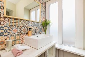 a bathroom with a white sink and a mirror at NEW! Charming Palmela Retreat near Arrábida&Castle in Palmela +17 photos