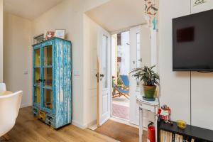 a living room with a blue cabinet and a tv at NEW! Charming Palmela Retreat near Arrábida&Castle in Palmela