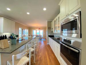 a large kitchen with white cabinets and a counter top at Lookout Point in Edisto Island