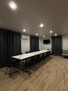a conference room with a long table and chairs at ChillVille in Ternopilʼ