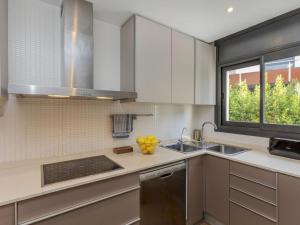 a kitchen with stainless steel appliances and a window at Holiday Home Sol Cambrils Park 28 by Interhome in Cambrils