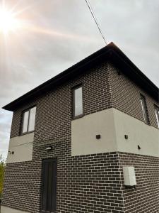 a brick building with a window on the side of it at ChillVille in Ternopilʼ