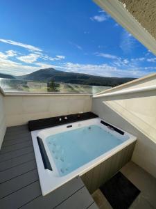 a jacuzzi tub on a balcony with a view at Hostal Restaurante Ibaisek in Zudaire +48 photos