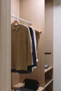 a closet with a shirt hanging on a rack at Outsite Barcelona - Work, Connect, Explore in Barcelona +46 photos