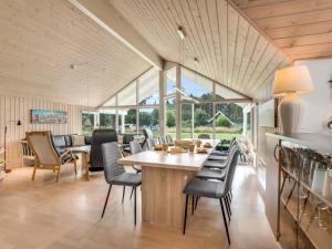 a dining room with a table and chairs at Holiday Home Dorde - 600m from the sea by Interhome in Rødby
