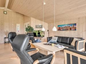a living room with leather chairs and a table at Holiday Home Dorde - 600m from the sea by Interhome in Rødby