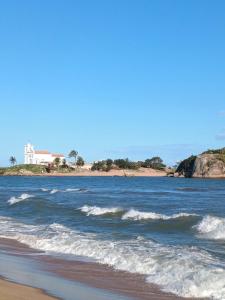 a view of the ocean from the beach at Flat confortavel e aconchegante in Cabo Frio
