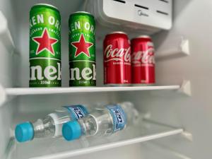 two cans of coca cola in a refrigerator at Mar de Corais Hospedagem in Serra