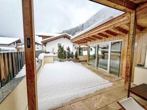 a view from the balcony of a house in the snow at Holiday Home Ferienhaus Sellraintal by Interhome in Gries im Sellrain