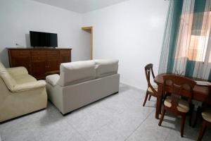 卡沃内拉斯Apartalux Luna Carboneras的客厅配有沙发、椅子和桌子