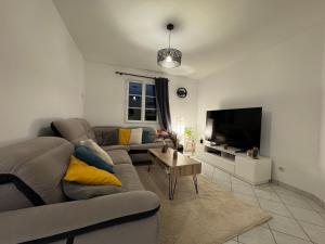 a living room with a couch and a tv at Les Lilas - 4pers - Circuit Bugatti in La Chapelle-Saint-Rémy