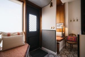 a room with a door and a bed and a desk at Maison Barthes Suites B&B in Baraqueville +91 photos