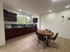 a kitchen with a table and chairs in a room at Carpe Diem Palora in Palora