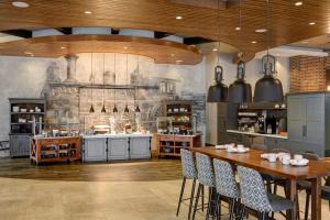 a large kitchen with a table and chairs at Archer Hotel Boston/Burlington in Burlington