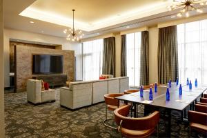a conference room with a long table and chairs at Archer Hotel Boston/Burlington in Burlington +59 photos