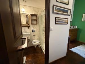 a bathroom with a toilet and a sink at Rafalias Mansion in Hydra