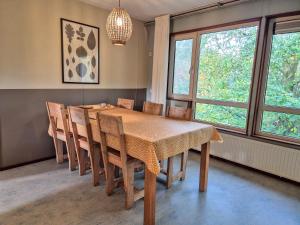 アムステルダムにあるAmsterdam Farm Lodgeのテーブルと椅子と窓のあるダイニングルーム