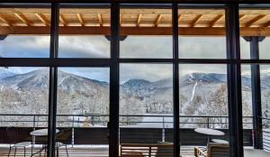 a room with a view of mountains through a window at Balcons de Sorgeat - Chambres d'hôtes - Ecolodge en montagne in Sorgeat