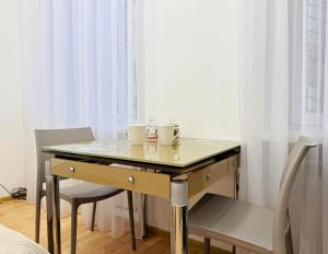 a table with two cups on it next to a window at Kyiv Gelik Apartment in Kyiv
