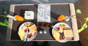 a tray of food with breakfast foods and orange juice at Hotel Yatri in Pokhara +69 photos