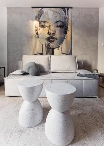 a bedroom with two white tables in front of a bed at Urban Nest in Szczecinek