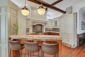 a kitchen with white cabinets and a large island at Home at 1014 in Savannah