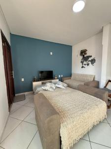 a living room with two beds and a couch at Duplex Belli a 300m do Mar in Natal