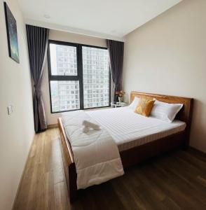 a bedroom with a large bed with two large windows at Nana Home in Kim Quan