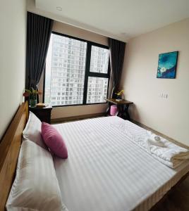 a bedroom with a large bed with a large window at Nana Home in Kim Quan