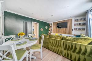 a dining room with a table and a couch at KILEX House contractor-friendly base in Bedlinog village in Bedlinog
