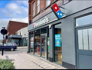 a dunkin donuts store on the side of a street at Burton Urban Apartment in Burton upon Trent