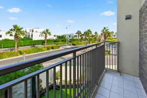 a balcony with a view of a street at 3BR Luxurious Villa pool view DAMAC Hills 2 in Dubai