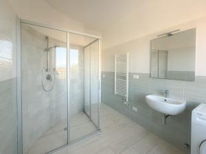 a bathroom with a glass shower and a sink at La Dimora di Bagnaja - HelloElba in Bagnaia +10 photos
