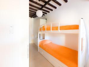 a bedroom with two bunk beds and an orange mattress at La Dimora di Bagnaja - HelloElba in Bagnaia