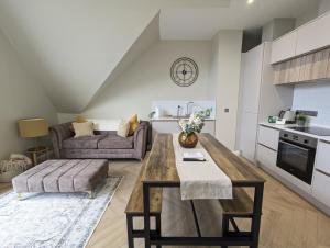een keuken en woonkamer met een tafel en een bank bij Waterfoot Penthouse Apartment in Newcastle +40 foto's