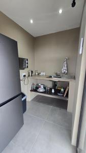 a kitchen with a sink and a counter in it at Izinga Game Karoo Guest Farm in Philipstown