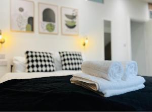 ein Stapel Handtücher auf einem Bett in der Unterkunft Yastayzzz at Apartment 4 Worcester House in Worcester